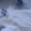 Moment woman is knocked off her mobility scooter by giant wave